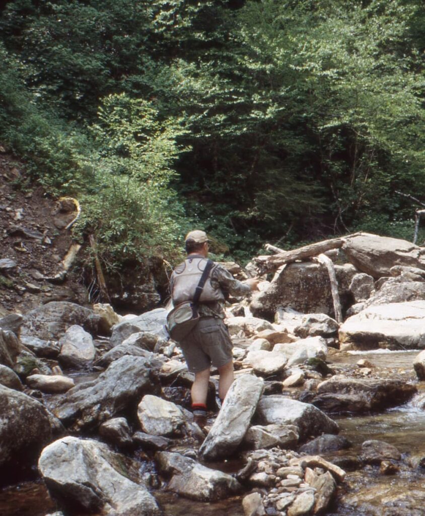 man in mountain creek