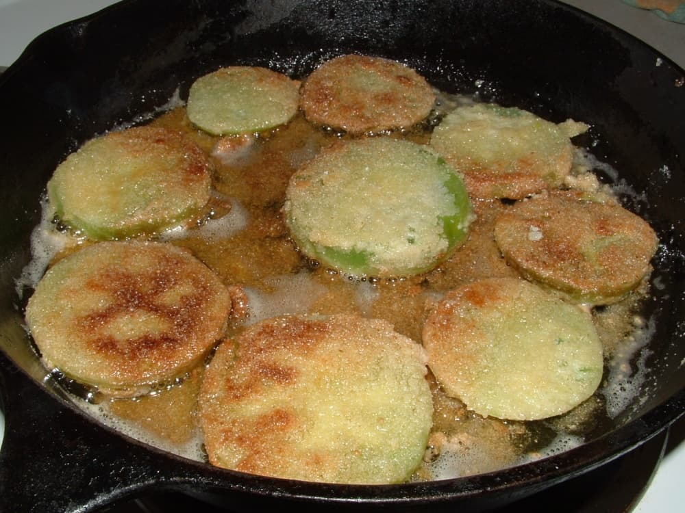 frying pan with green tomatoes